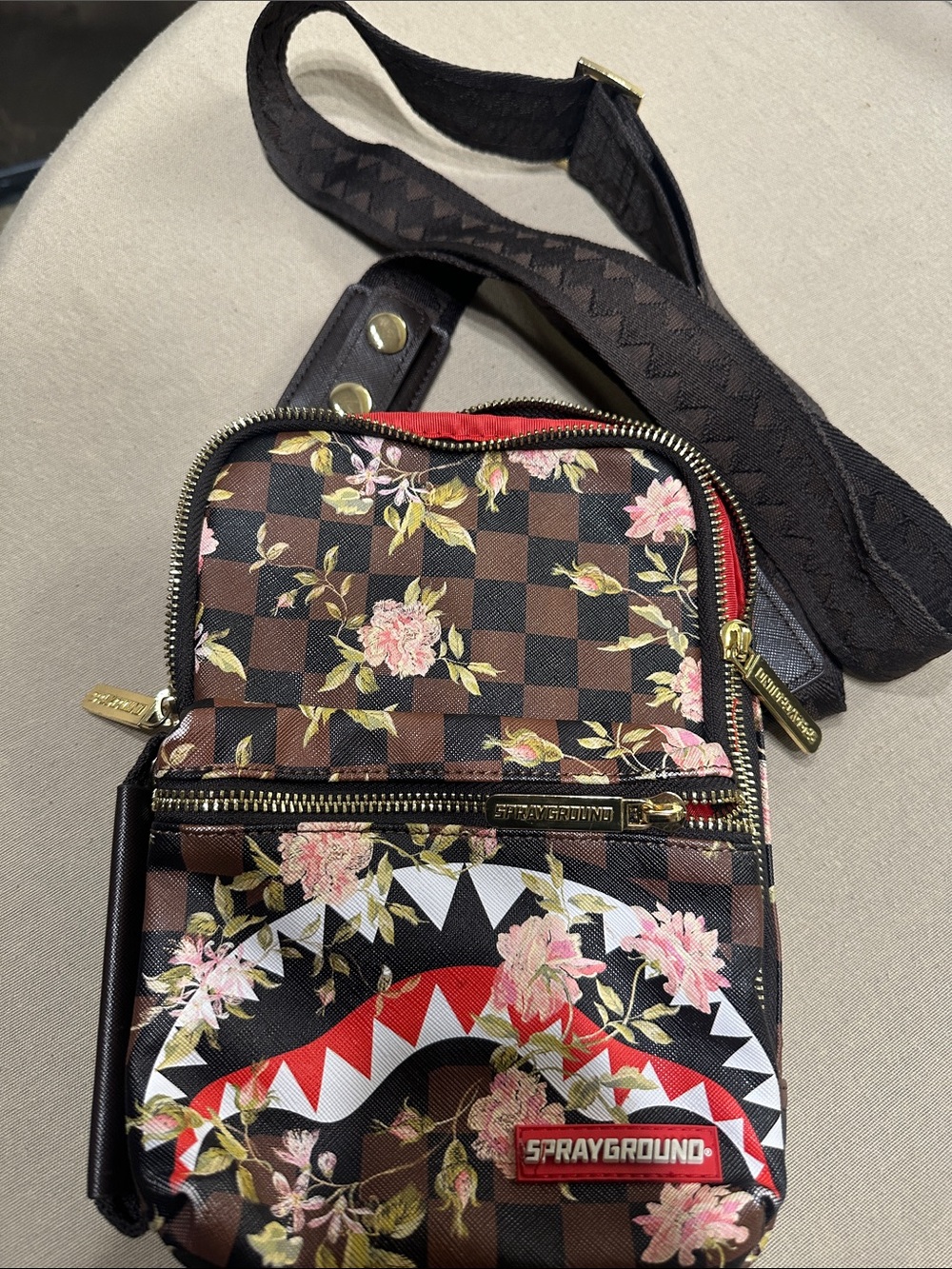Sprayground Brown Floral Checkered Crossbody with Red Shark Accent